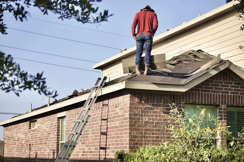 Professional roofer working on a residential roof in Presidents